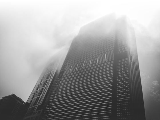 Office towers rising into fog